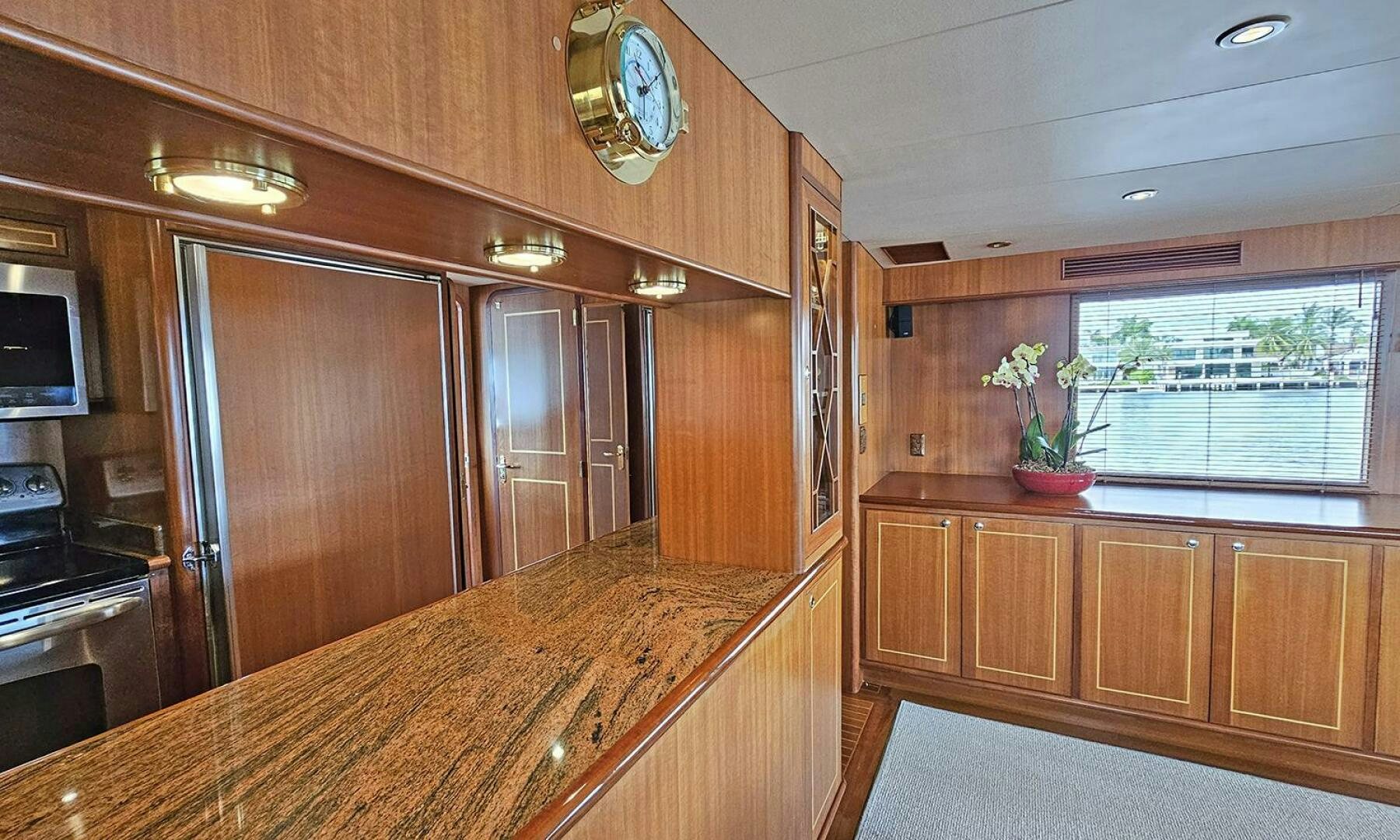 a kitchen with wooden cabinets aboard SHAMROCK Yacht for Sale