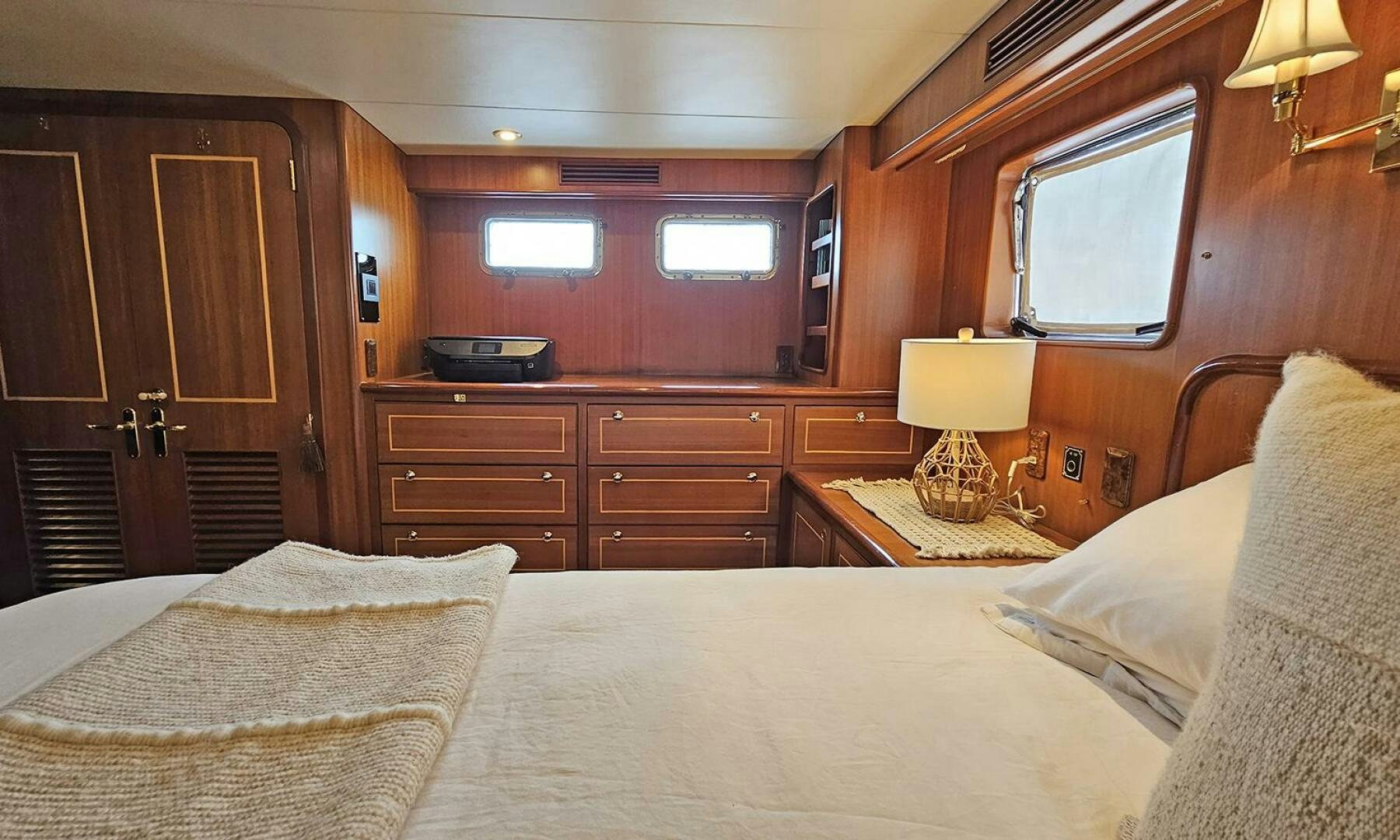 a bedroom with a bed and a dresser aboard SHAMROCK Yacht for Sale