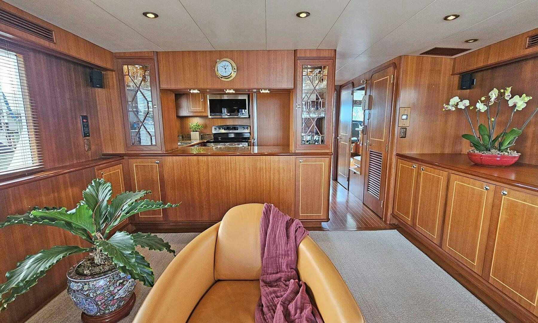 a living room with wooden cabinets aboard SHAMROCK Yacht for Sale