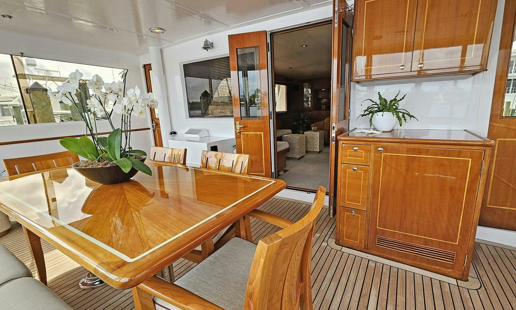 a room with a table chairs and plants aboard SHAMROCK Yacht for Sale