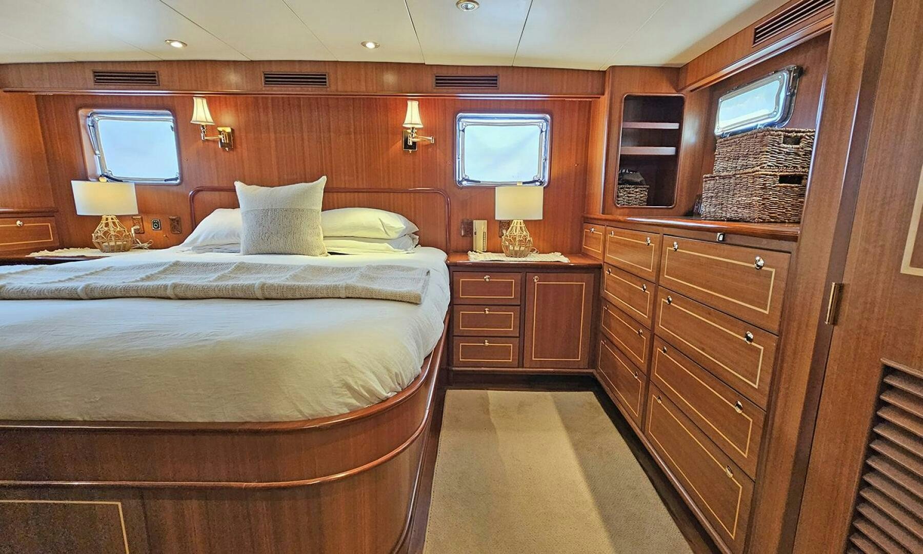 a bedroom with a bed and a dresser aboard SHAMROCK Yacht for Sale