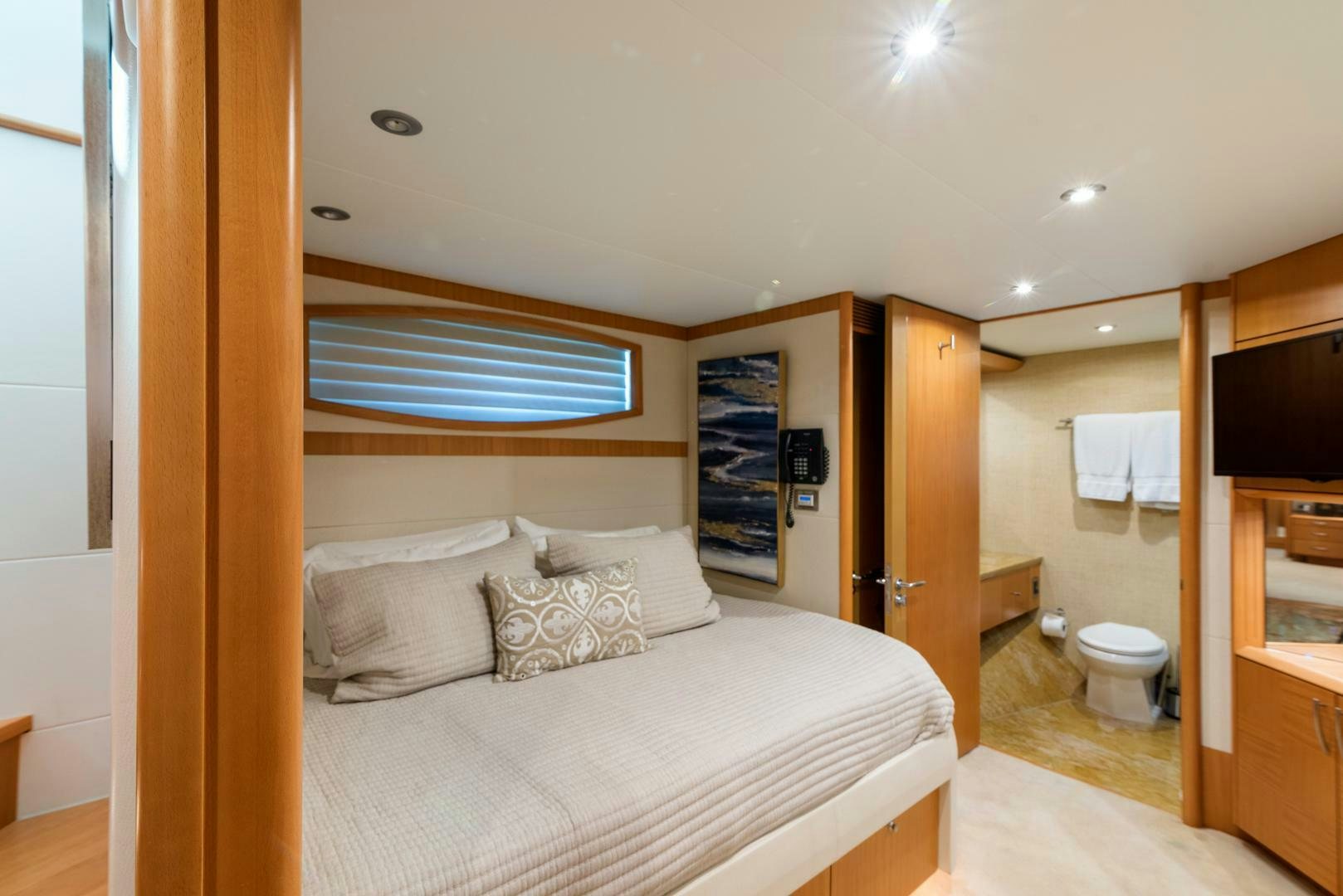 a bedroom with a bed and a television aboard SERENITY Yacht for Sale
