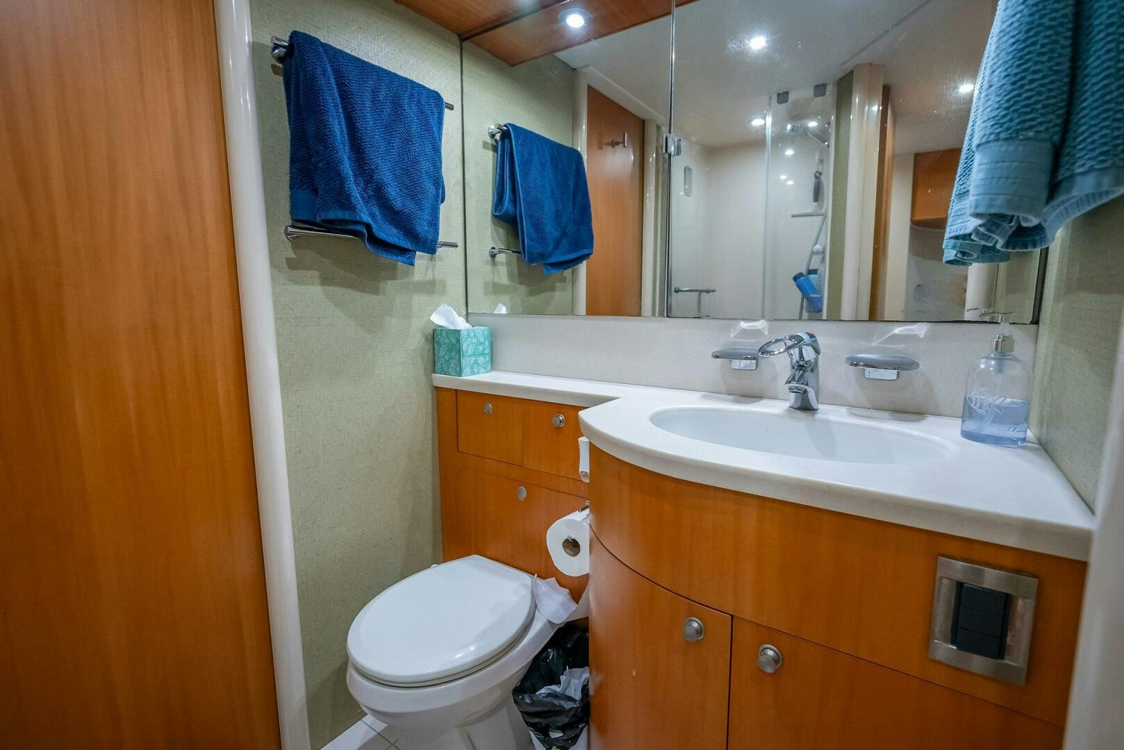a bathroom with a toilet and a sink aboard SERENITY Yacht for Sale