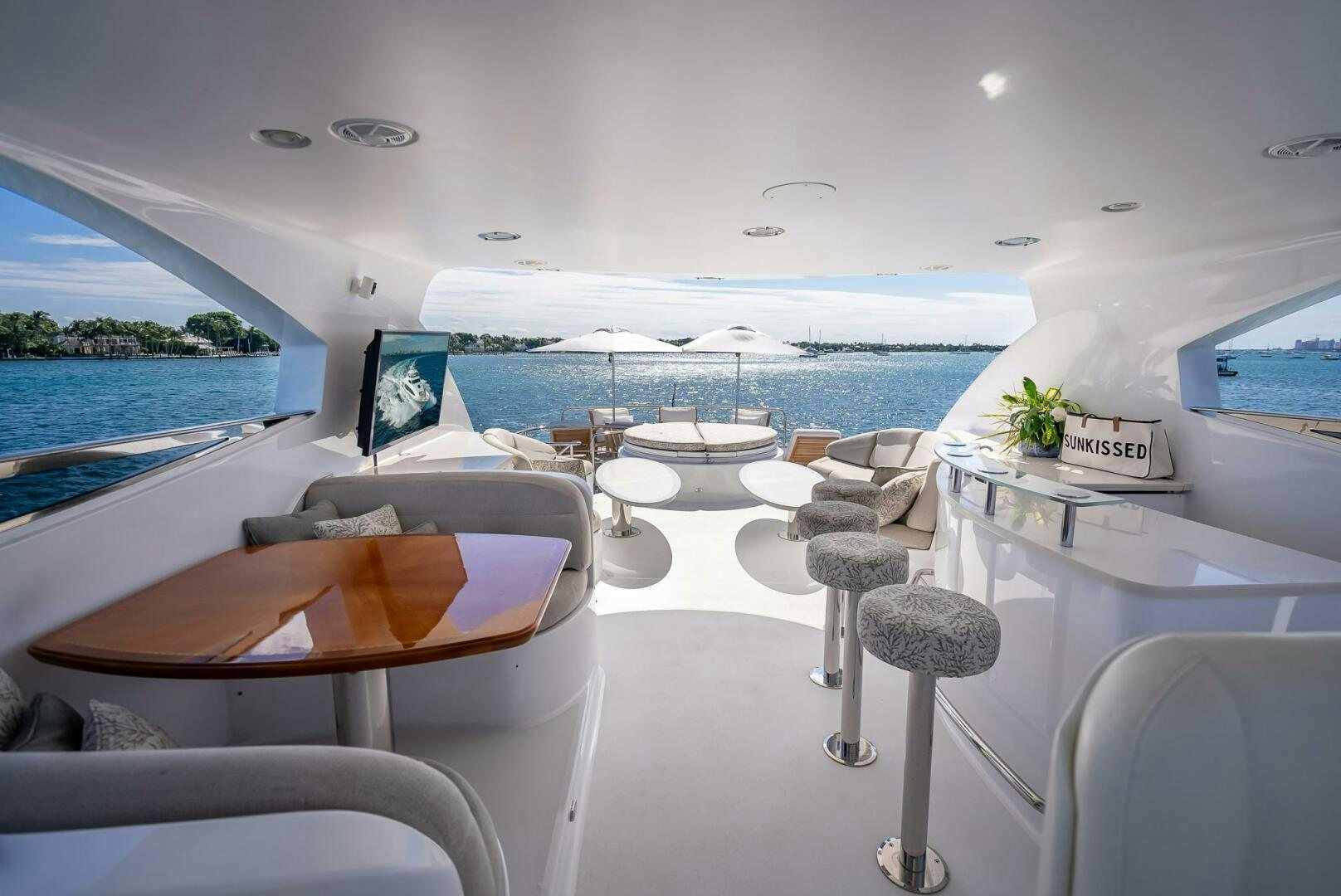 a room with a table chairs and umbrellas aboard SERENITY Yacht for Sale
