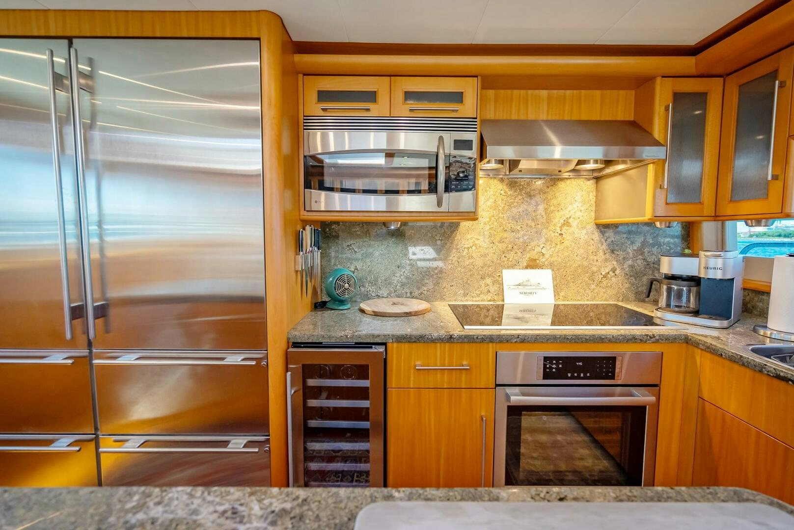 a kitchen with wooden cabinets aboard SERENITY Yacht for Sale