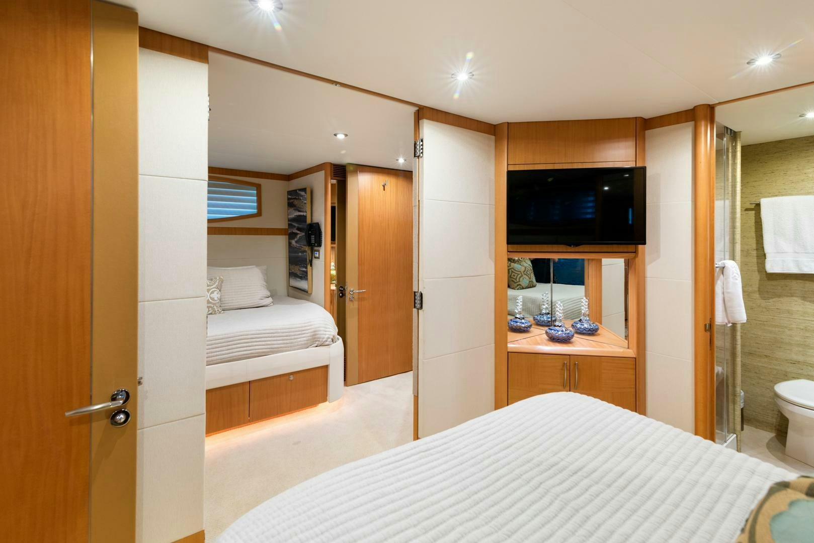 a hotel room with a bed and a glass of wine aboard SERENITY Yacht for Sale