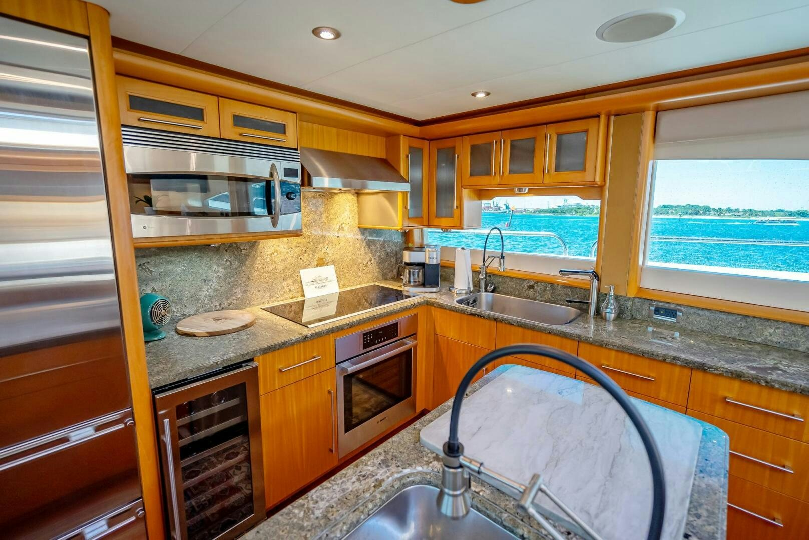 a kitchen with wooden cabinets aboard SERENITY Yacht for Sale