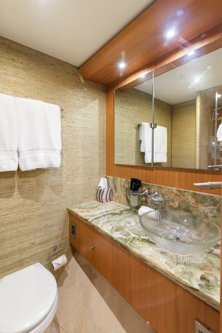 a bathroom with a large mirror aboard SERENITY Yacht for Sale