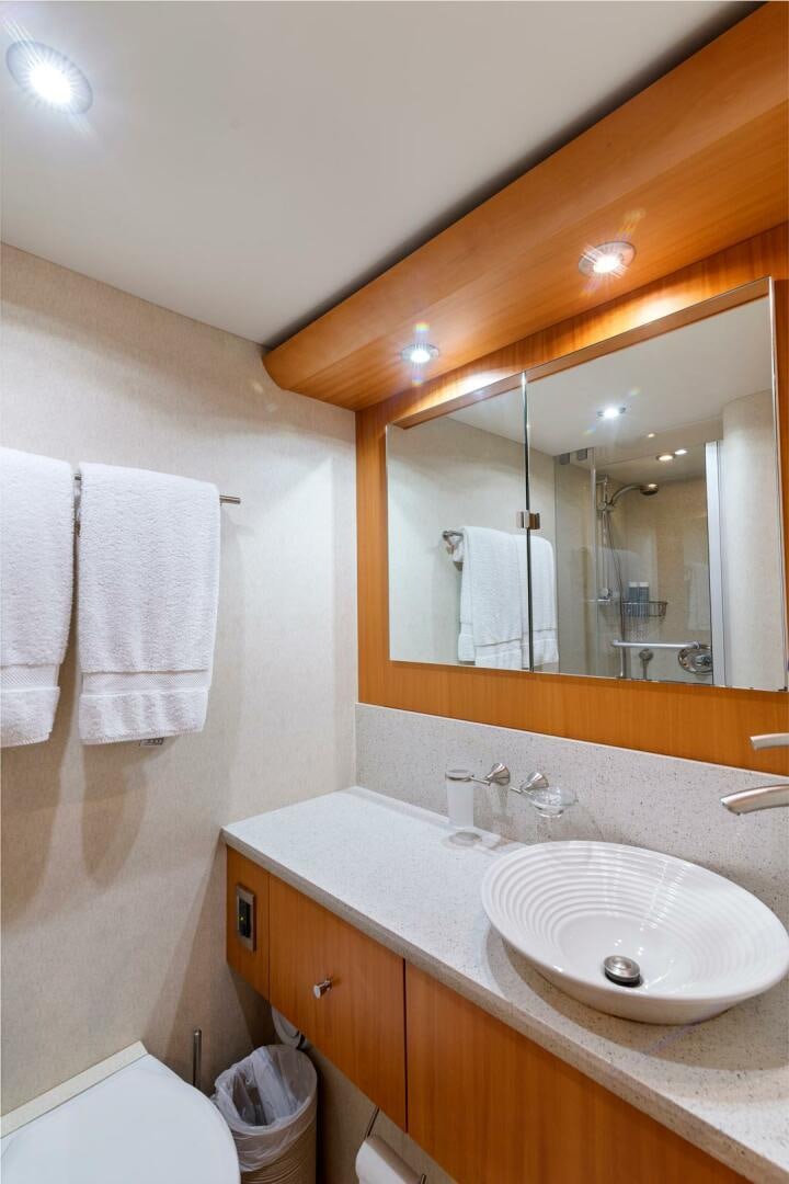 a bathroom with a sink and a mirror aboard SERENITY Yacht for Sale