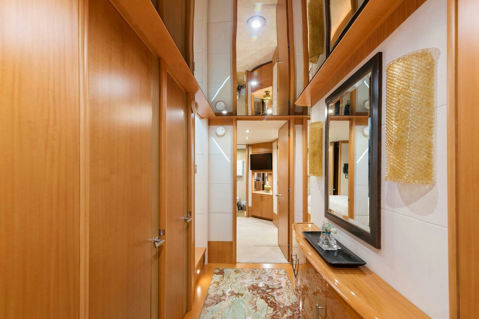 a room with a mirror and wood cabinets aboard SERENITY Yacht for Sale
