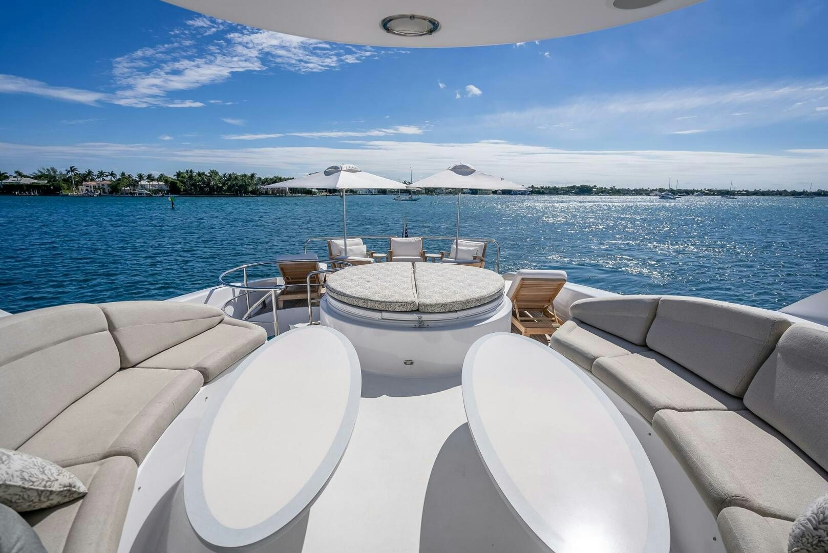 a white boat on a large body of water aboard SERENITY Yacht for Sale