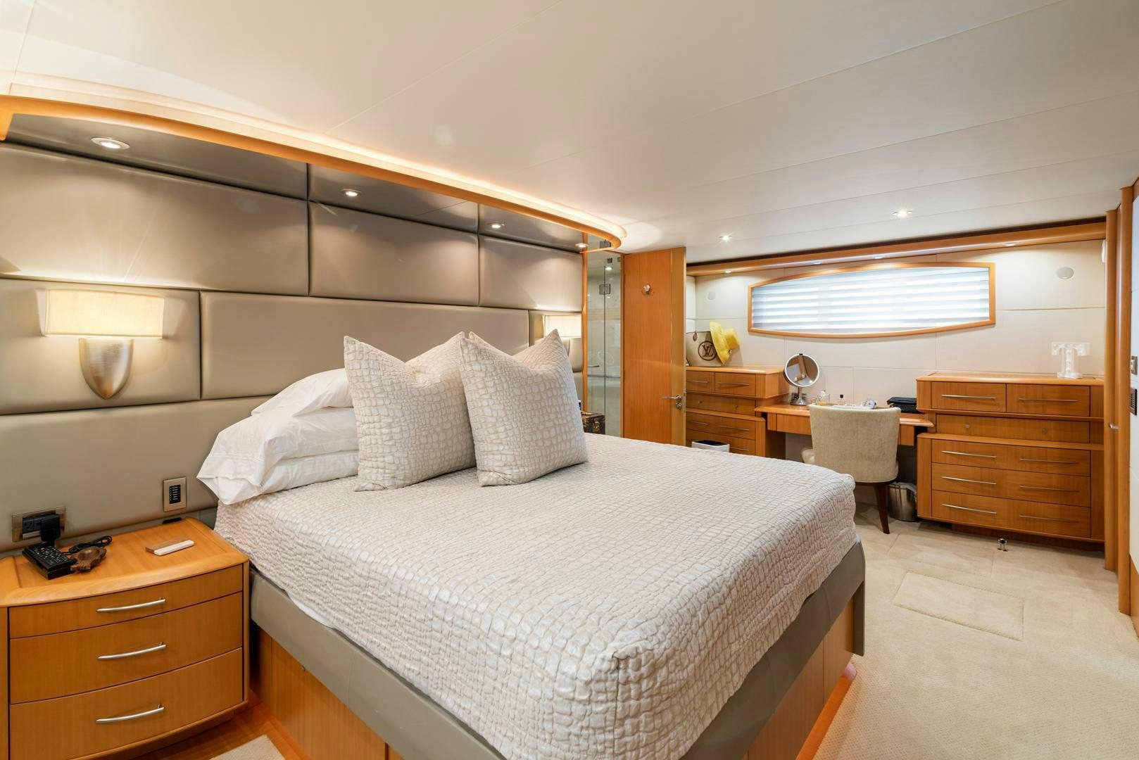 a bedroom with a bed and desk aboard SERENITY Yacht for Sale