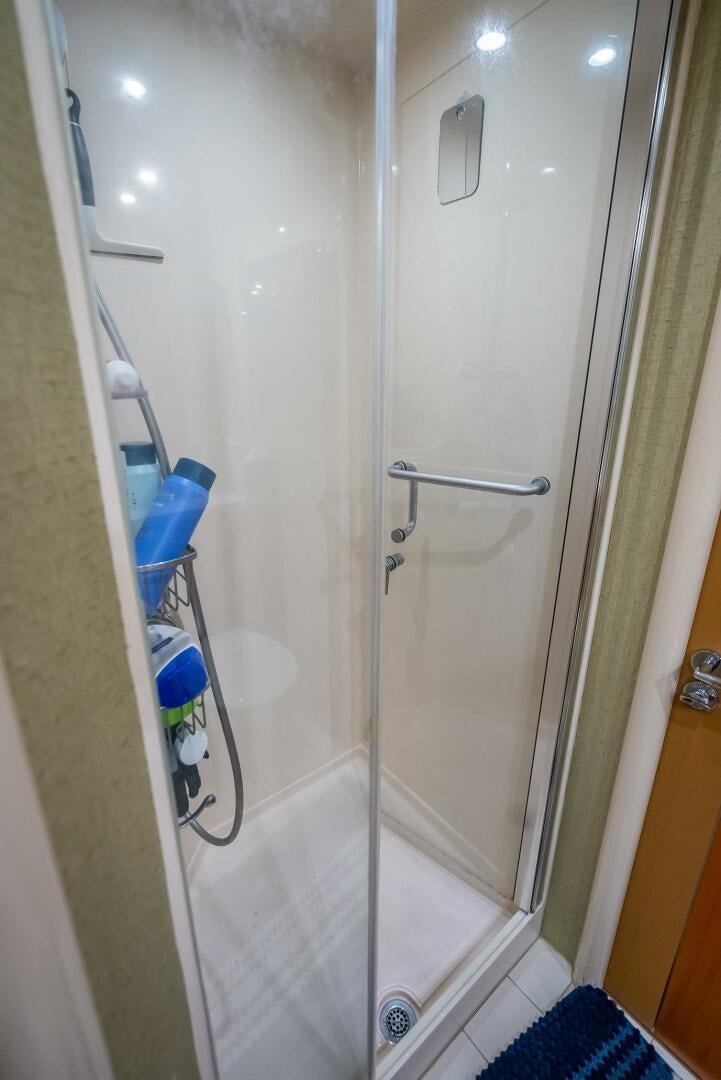 a shower with a glass door aboard SERENITY Yacht for Sale