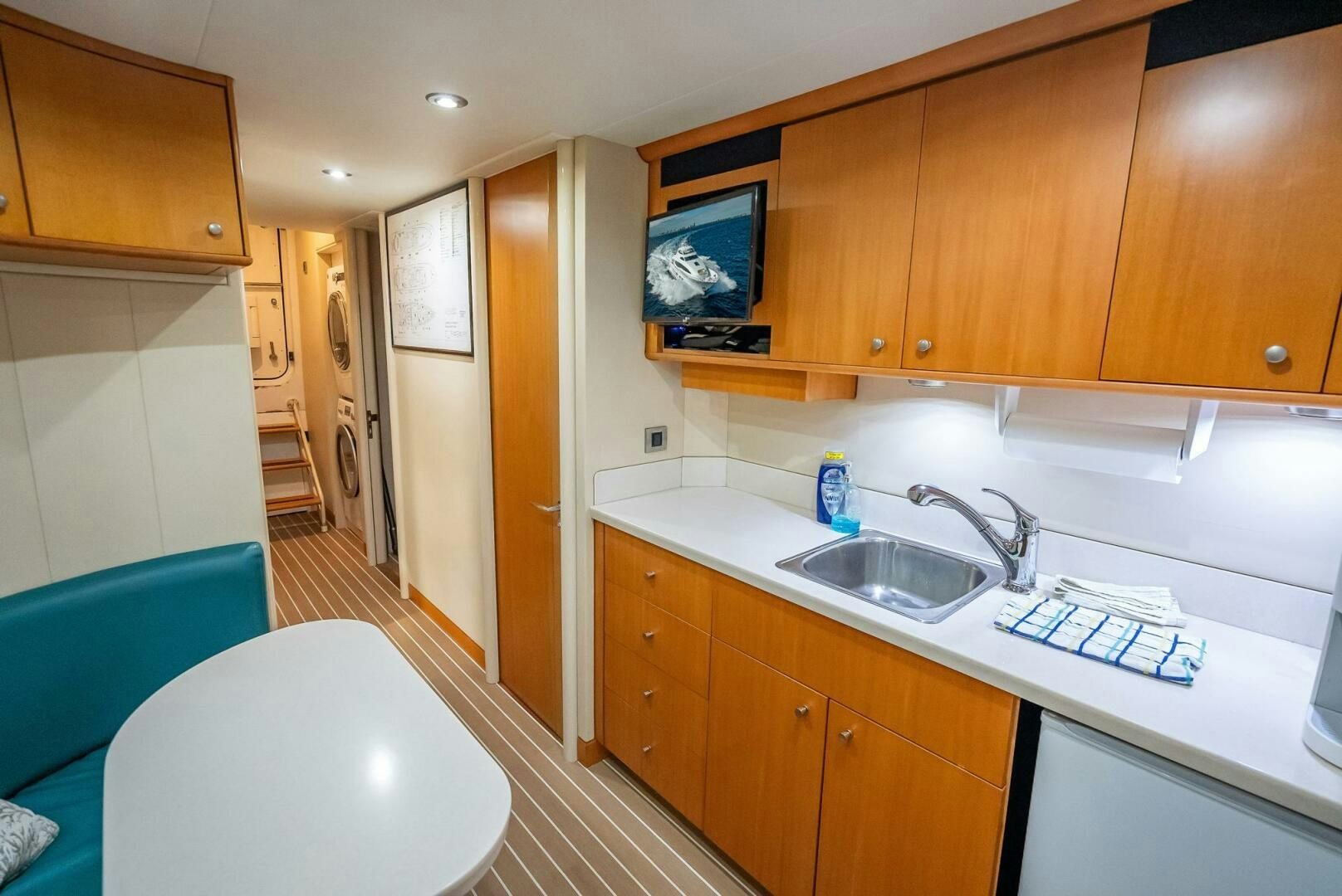 a kitchen with wooden cabinets aboard SERENITY Yacht for Sale
