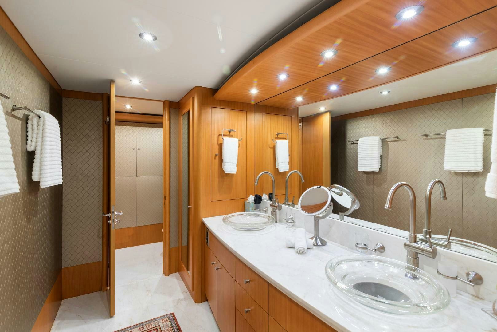 a bathroom with a sink and a mirror aboard SERENITY Yacht for Sale