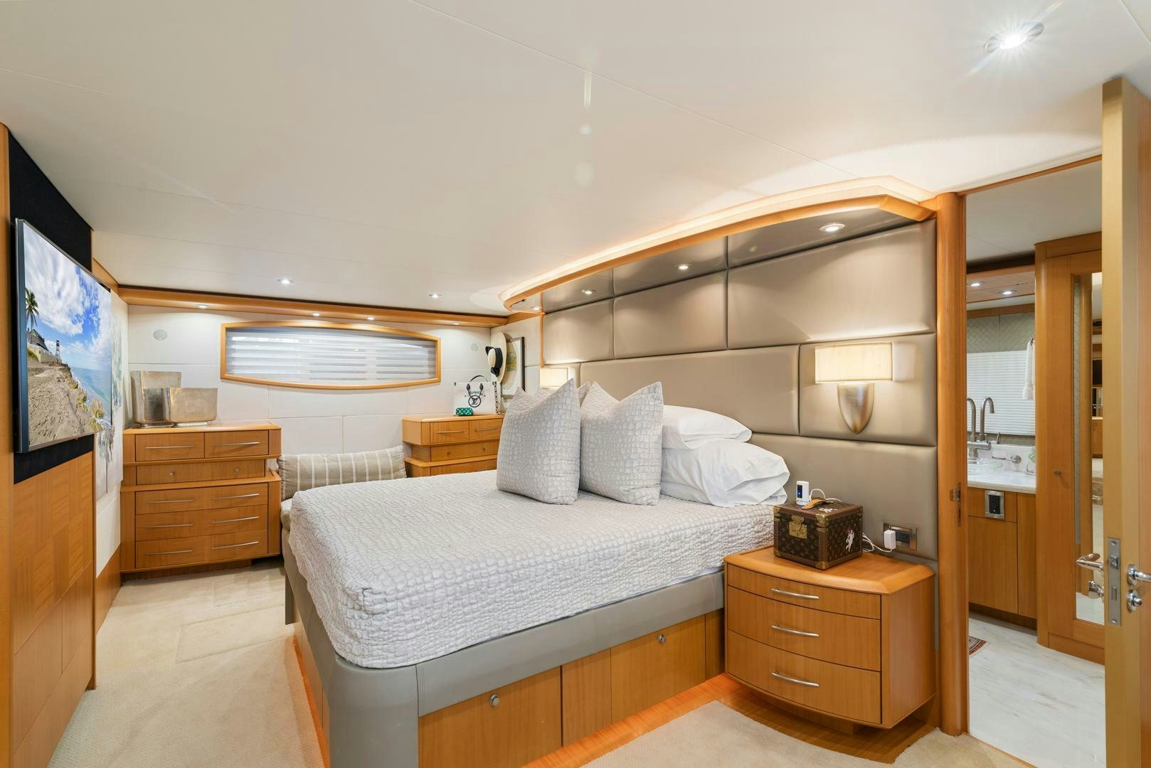 a bedroom with a bed and a dresser aboard SERENITY Yacht for Sale