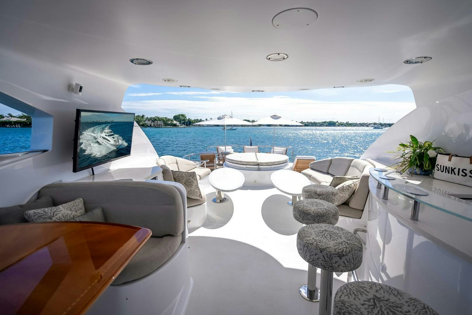 a room with a table chairs and a large body of water aboard SERENITY Yacht for Sale