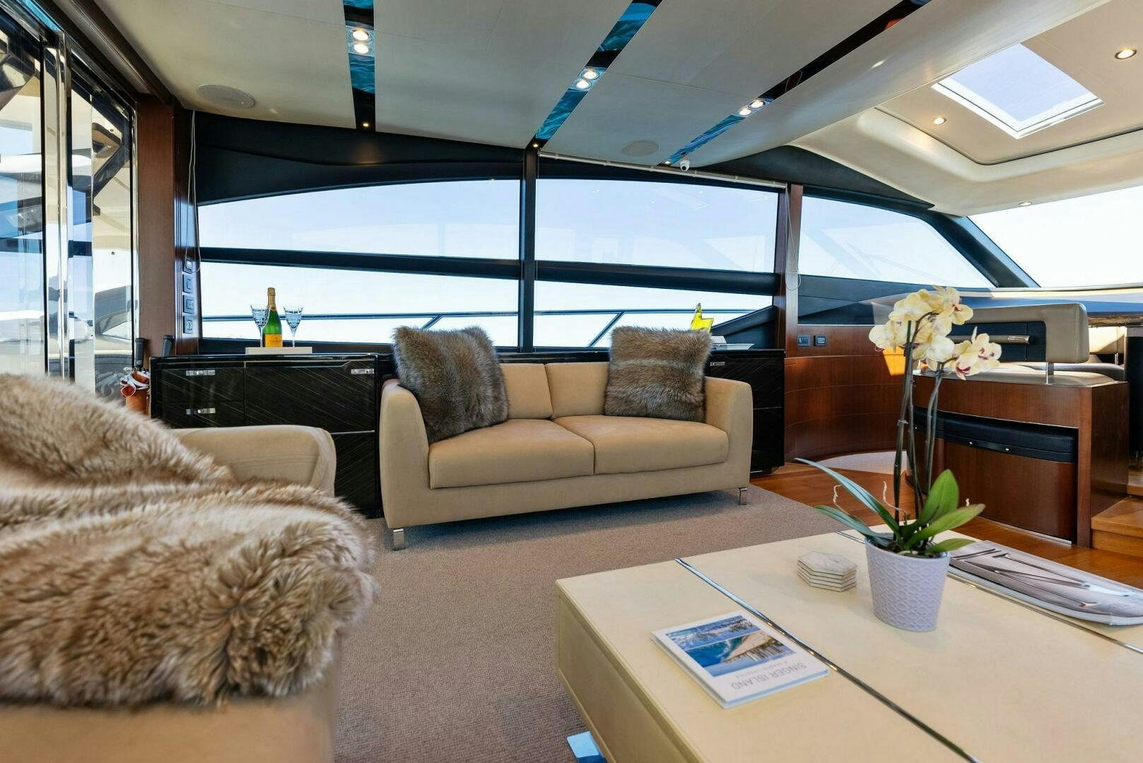 a living room with couches and a table aboard WOODY Yacht for Sale