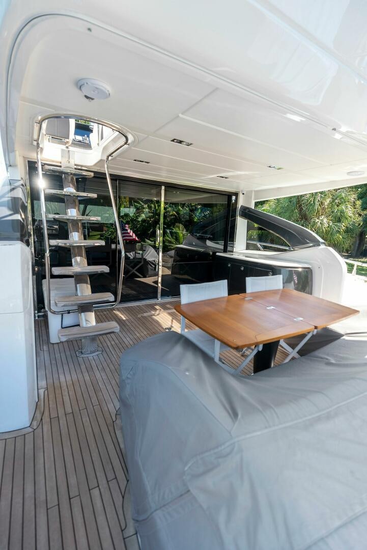 a table and chairs in a room aboard WOODY Yacht for Sale