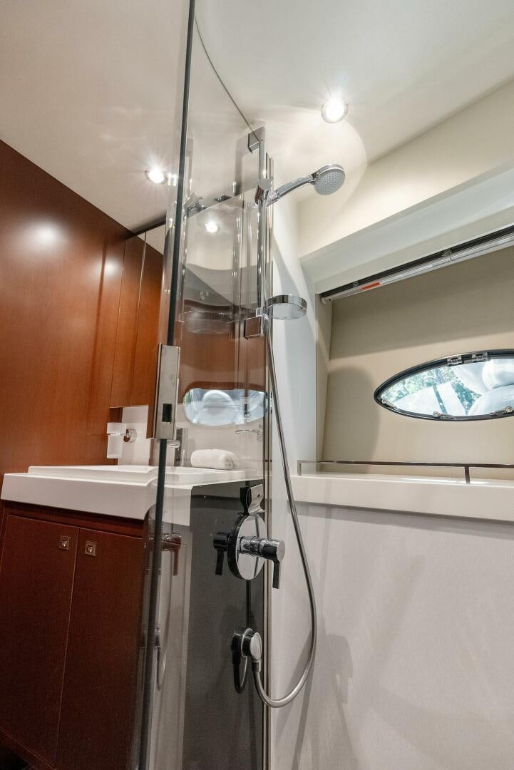 a shower unit with a glass door aboard WOODY Yacht for Sale
