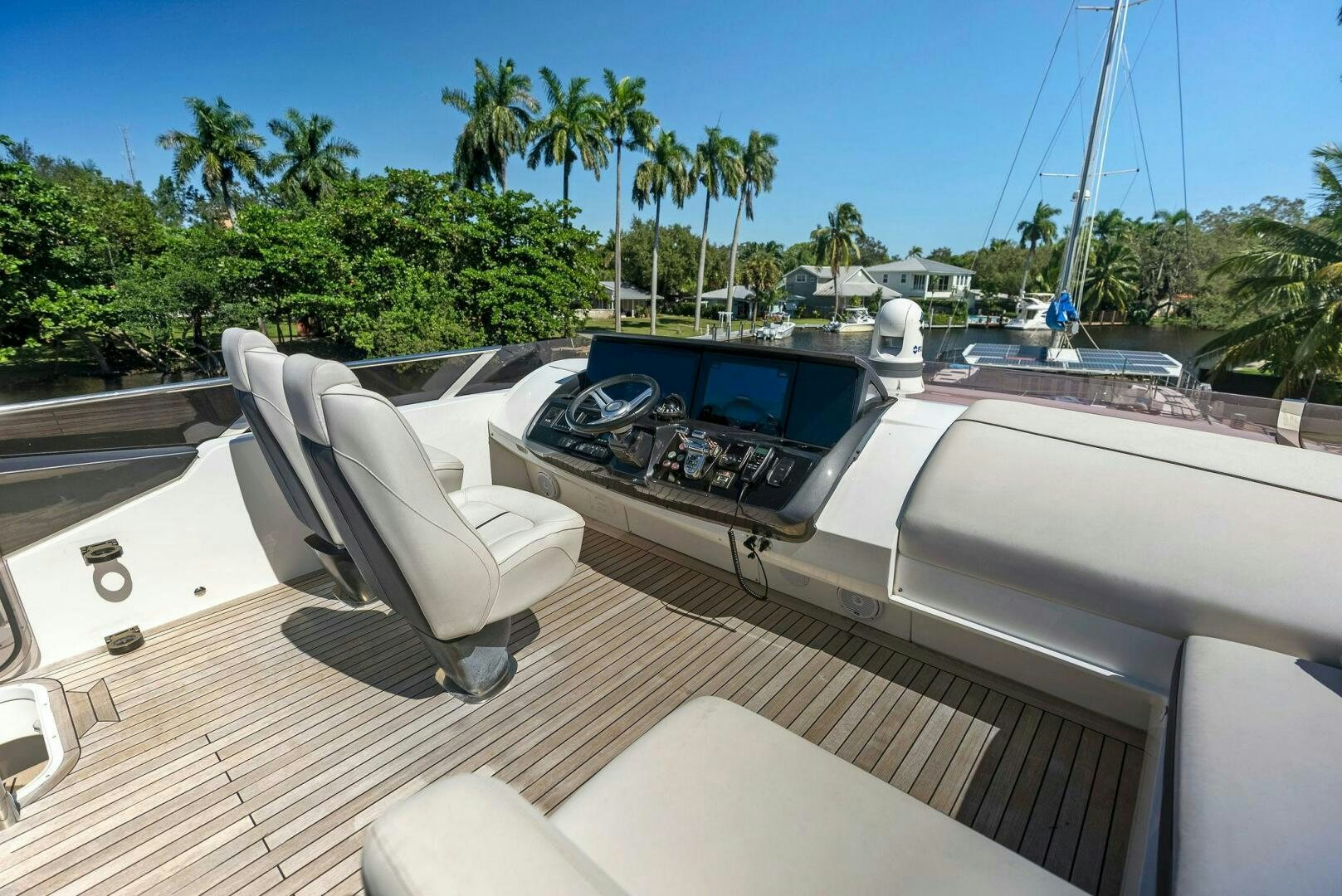 a white lounge chair on a deck overlooking a tropical area aboard WOODY Yacht for Sale