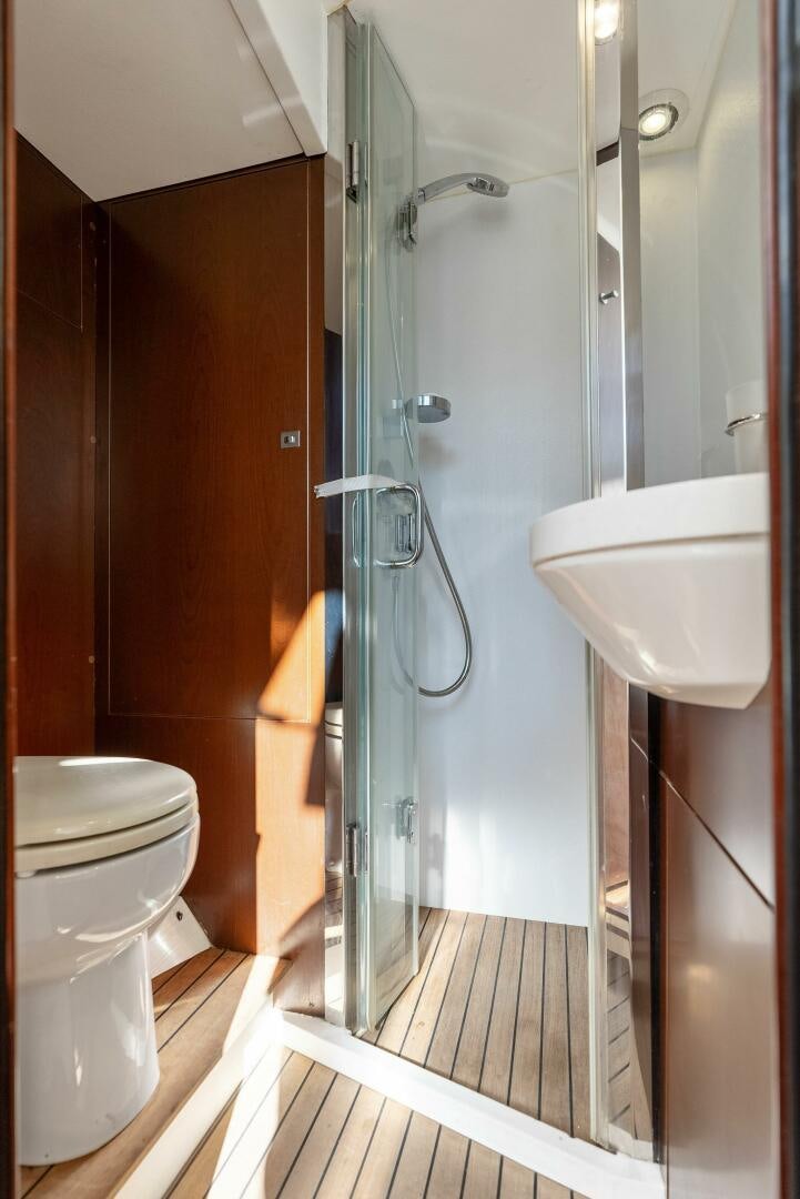 a bathroom with a glass shower aboard WOODY Yacht for Sale