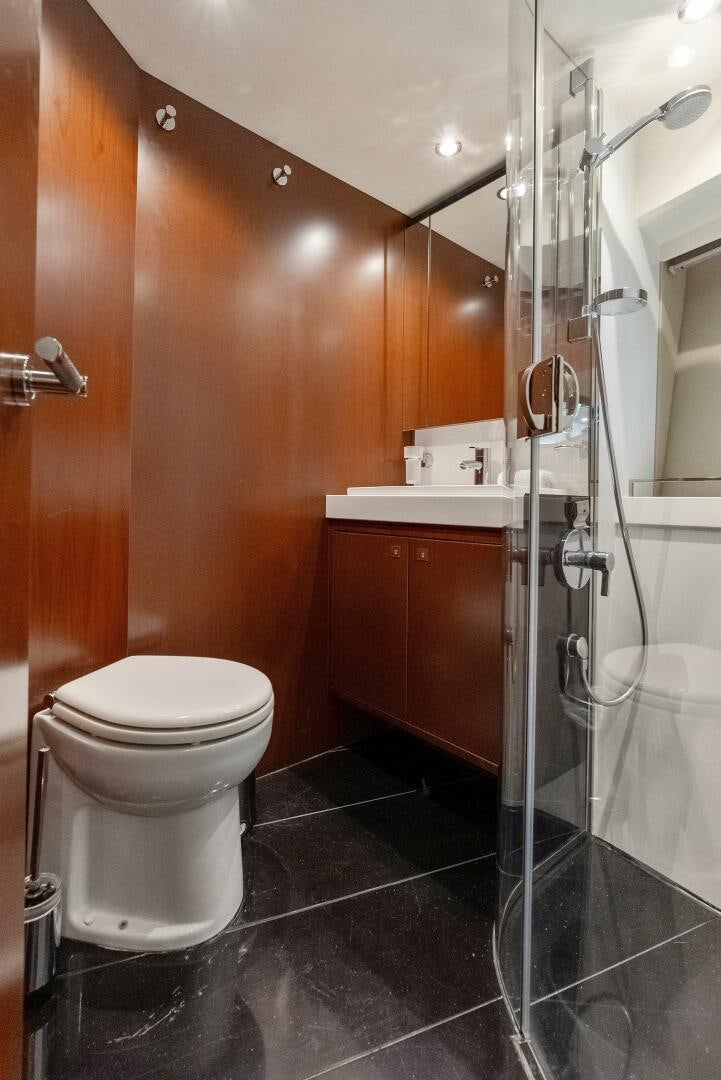 a bathroom with a glass shower aboard WOODY Yacht for Sale