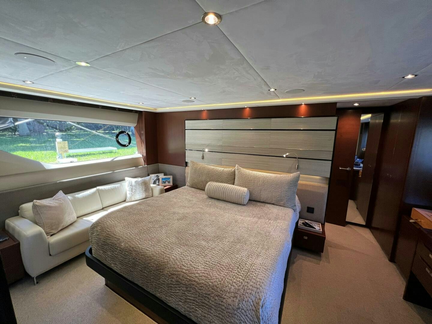 a room with a bed and a couch aboard WOODY Yacht for Sale