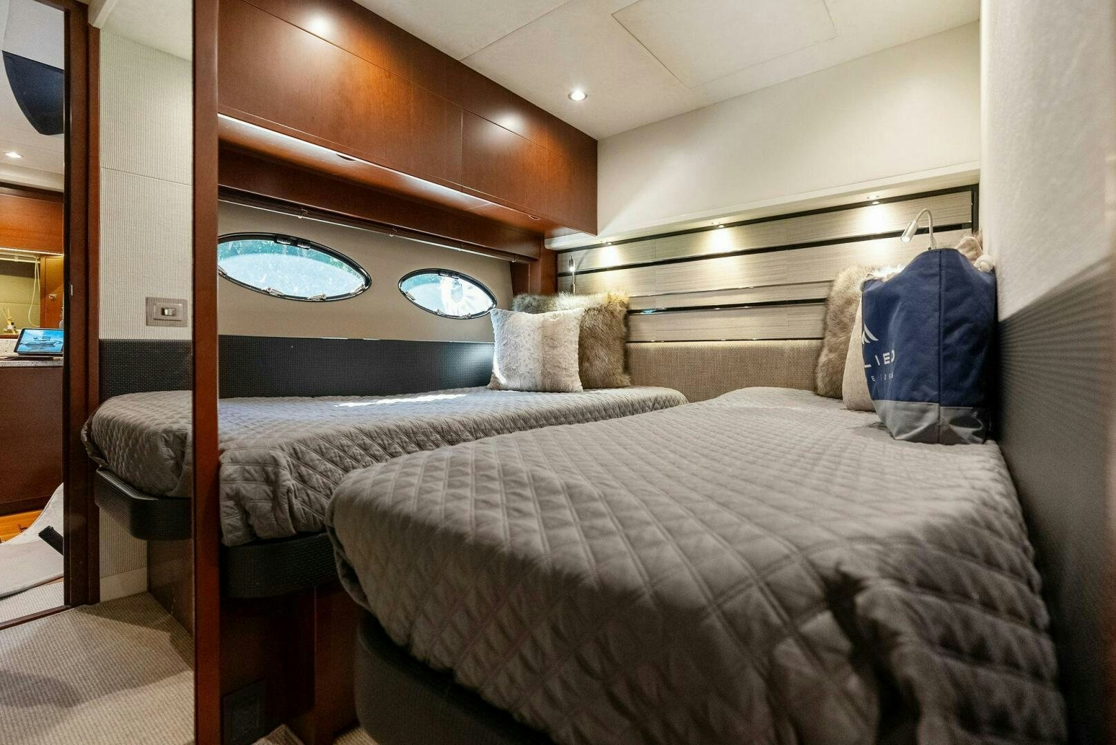 a bed with a mirror above it aboard WOODY Yacht for Sale