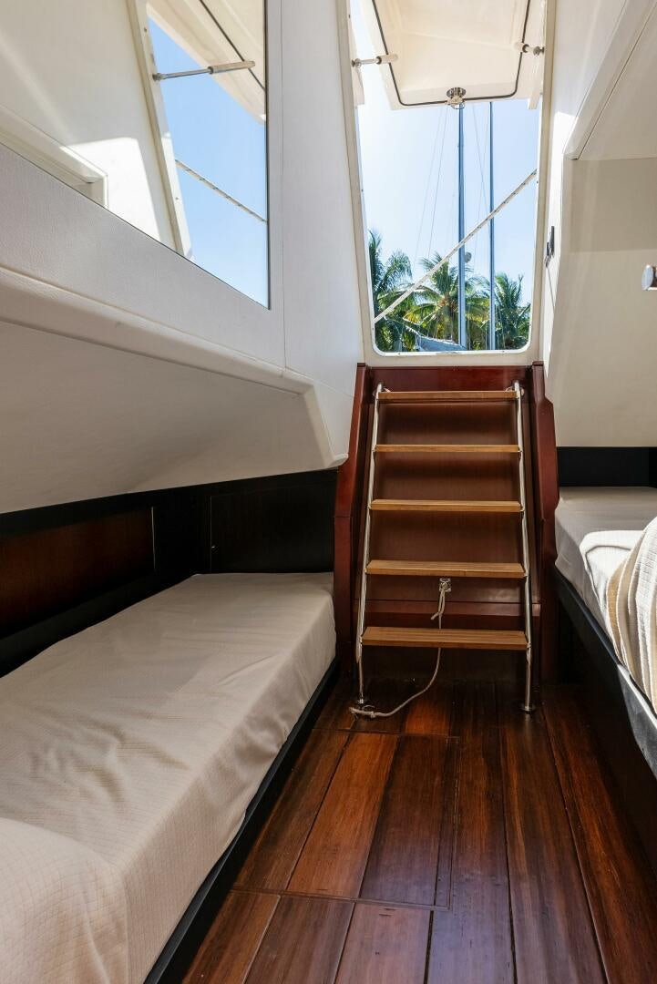 a bed and a window aboard WOODY Yacht for Sale