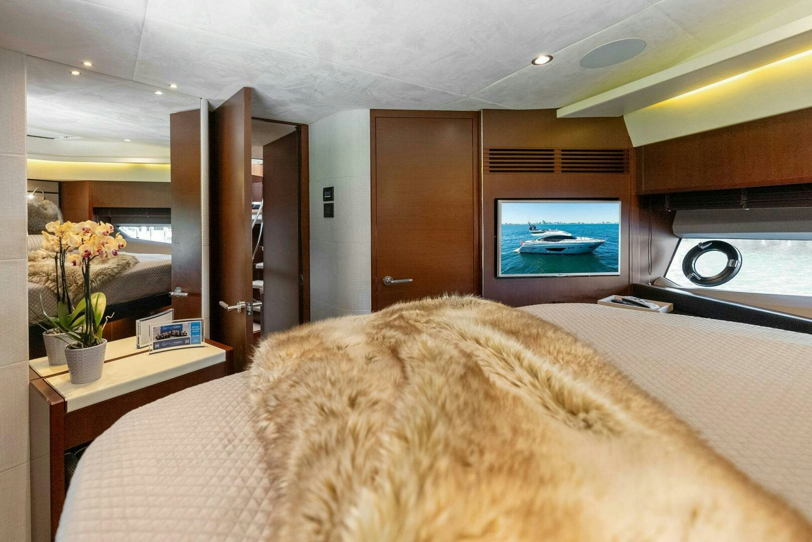a bedroom with a large television aboard WOODY Yacht for Sale