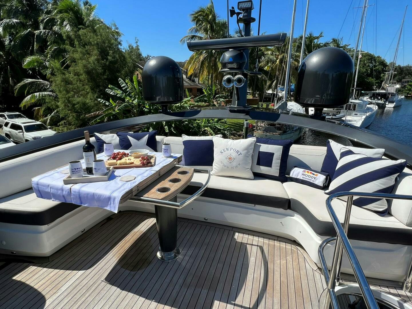 a white couch with a table and chairs on it aboard WOODY Yacht for Sale