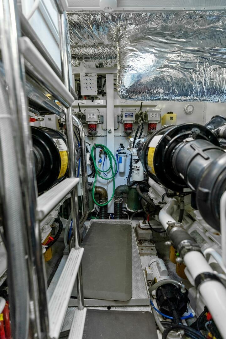 a large white machine with a blue line on the side aboard WOODY Yacht for Sale