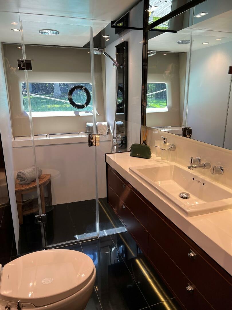 a bathroom with a sink and a mirror aboard WOODY Yacht for Sale