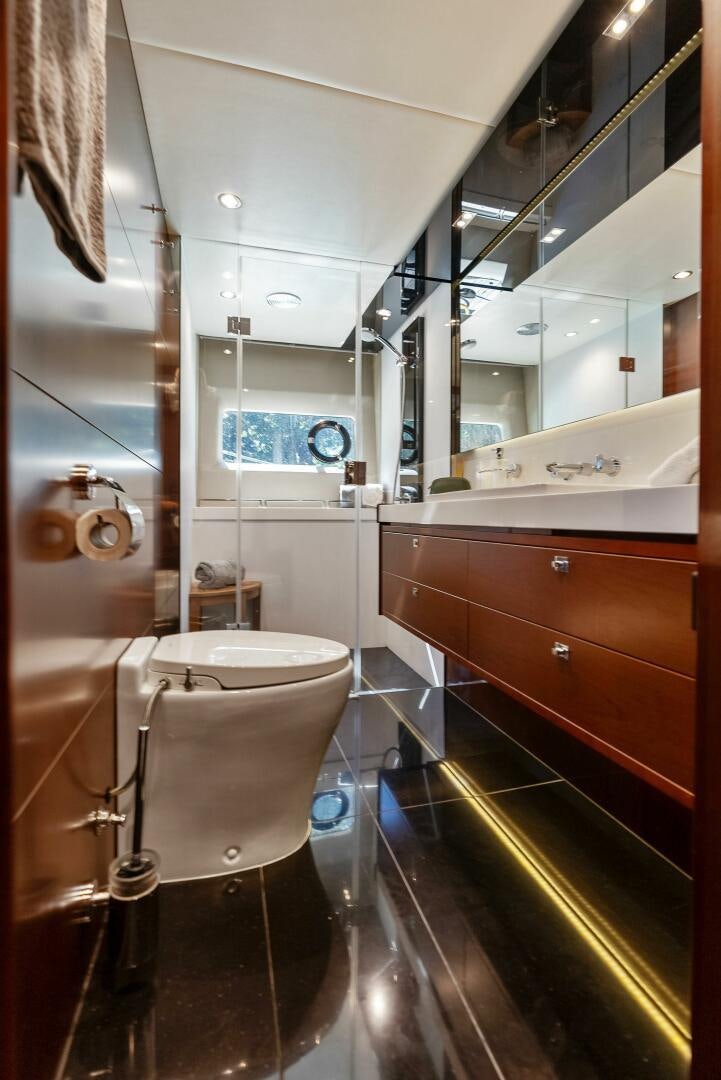 a bathroom with a large mirror aboard WOODY Yacht for Sale