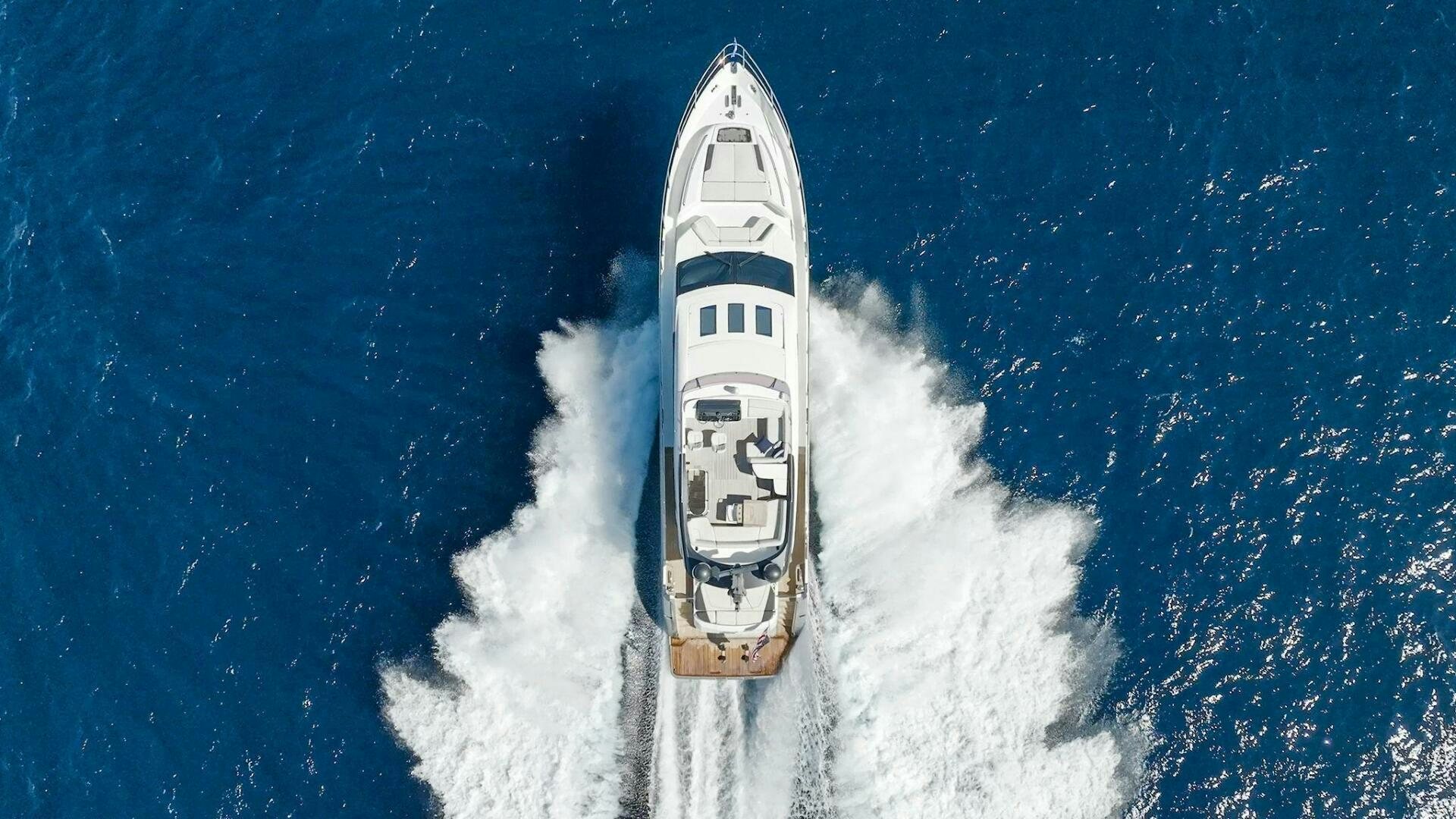 a white boat with smoke coming out of it aboard WOODY Yacht for Sale