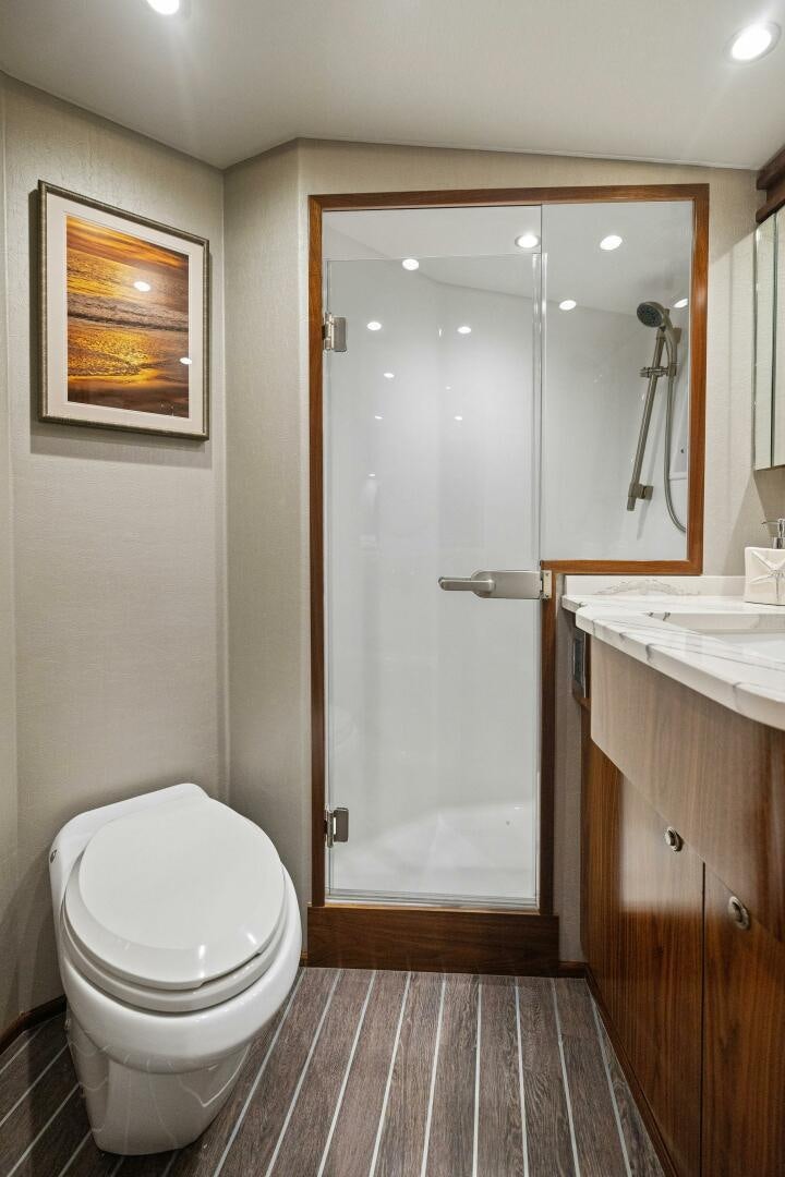 a bathroom with a shower and toilet aboard PLAN B Yacht for Sale