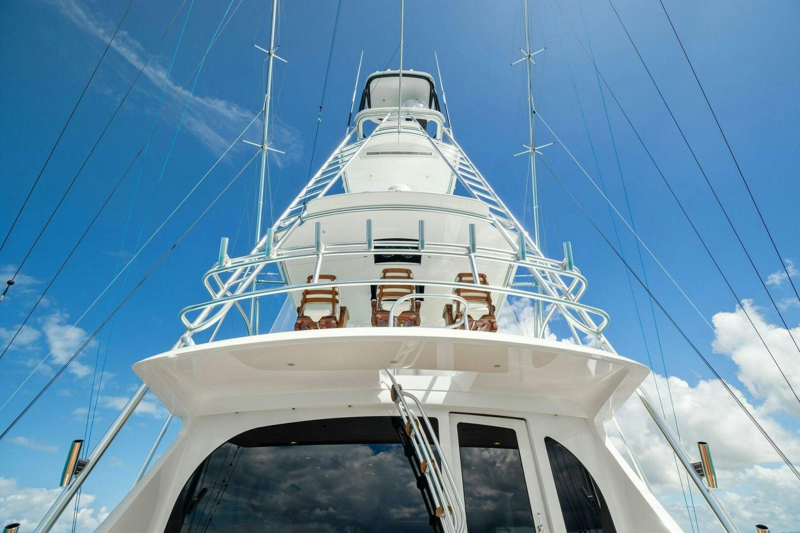 a white boat with blue sky aboard PLAN B Yacht for Sale