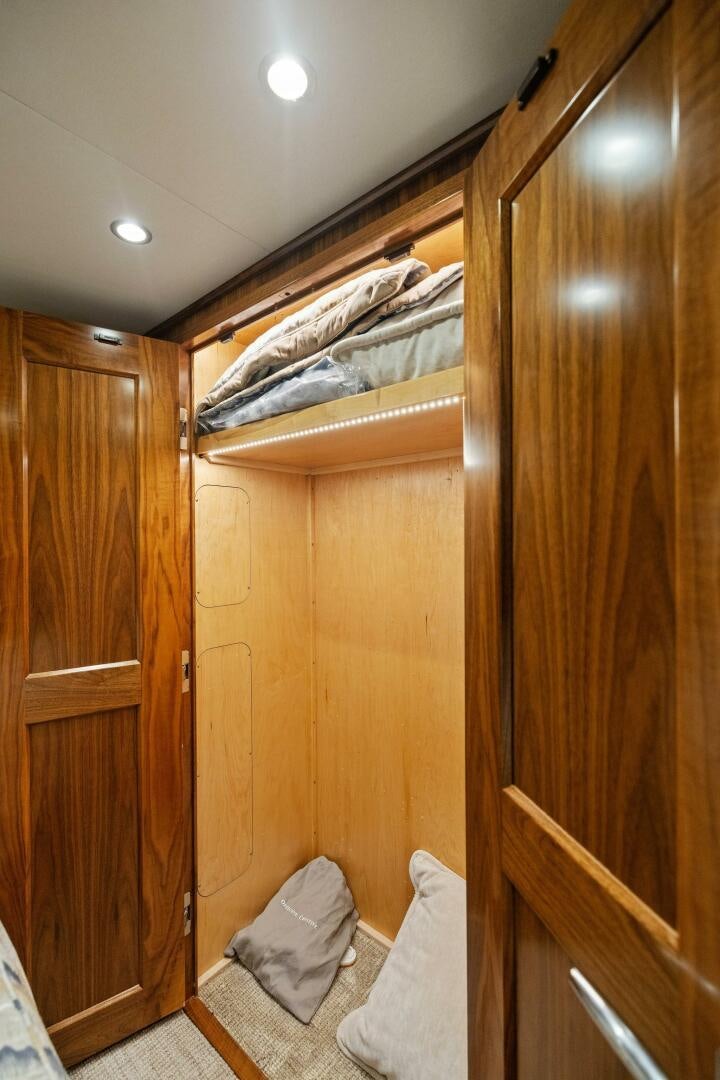 a room with wooden cabinets aboard PLAN B Yacht for Sale