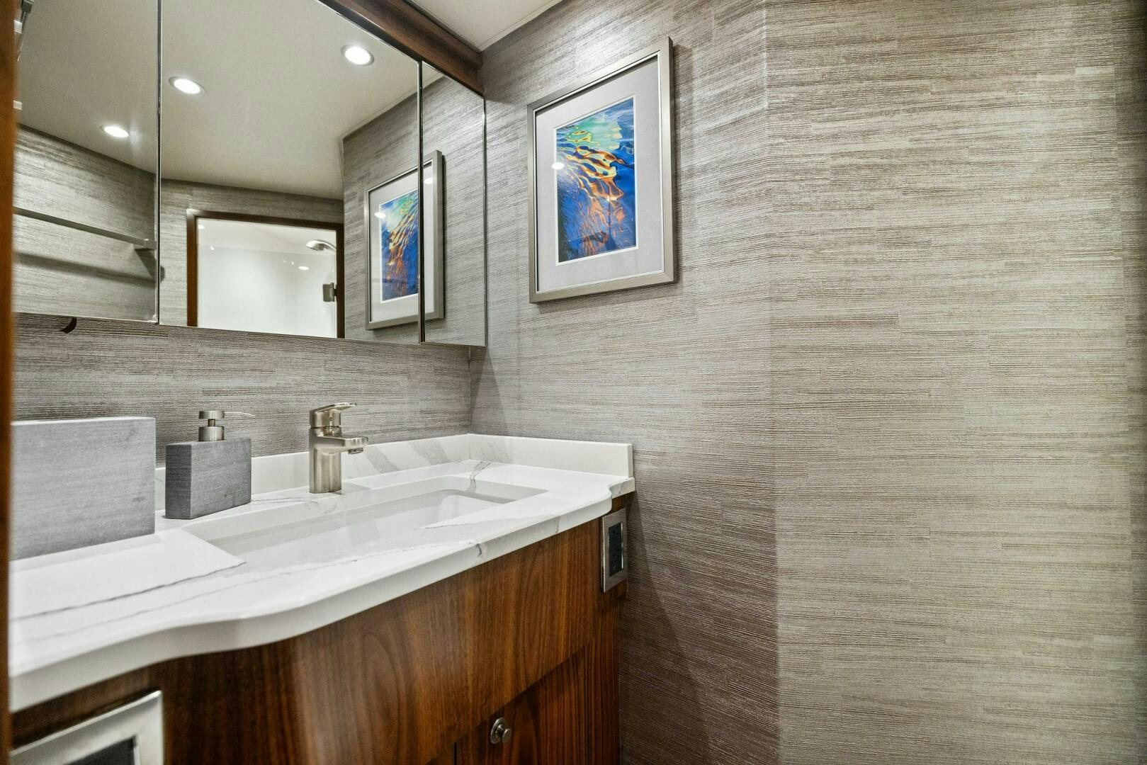 a bathroom with a sink and a mirror aboard PLAN B Yacht for Sale
