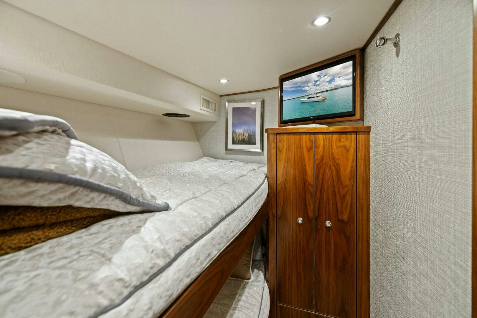 a bedroom with a tv on the wall aboard PLAN B Yacht for Sale