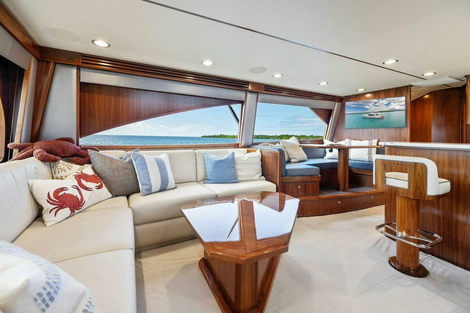 a living room with a large window aboard PLAN B Yacht for Sale