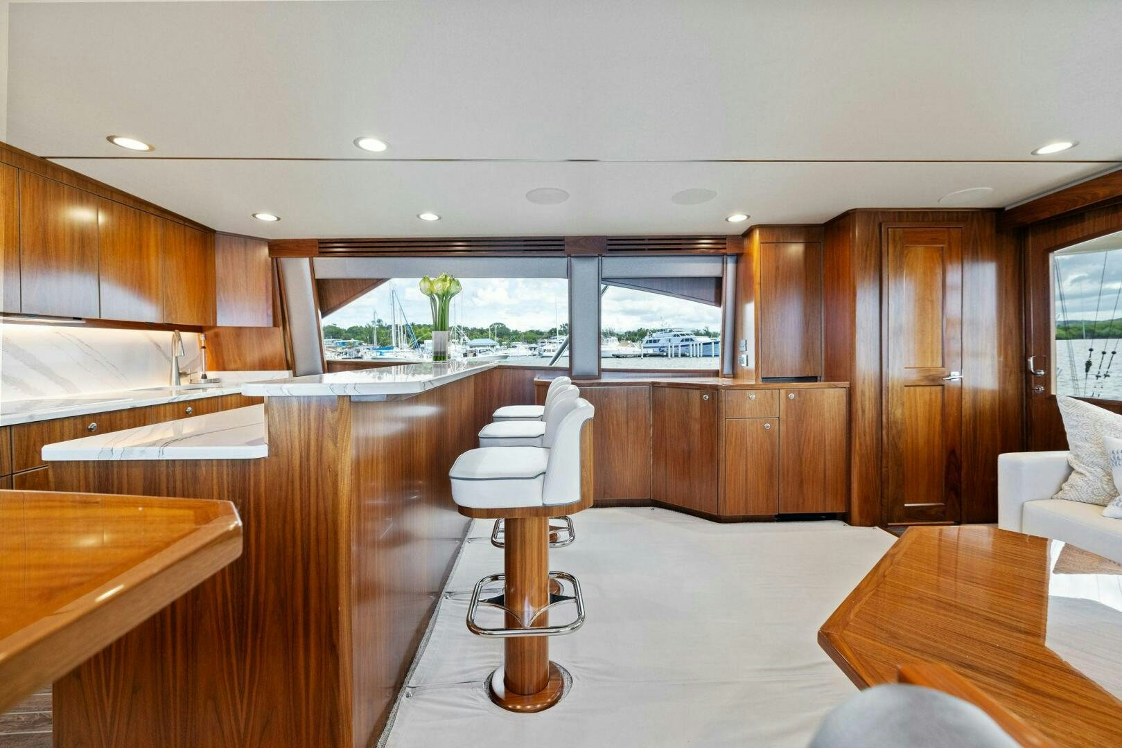 a room with a wood floor and a wood cabinet and a white chair aboard PLAN B Yacht for Sale
