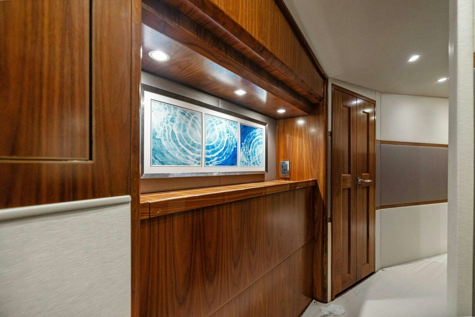 a room with wooden cabinets aboard PLAN B Yacht for Sale