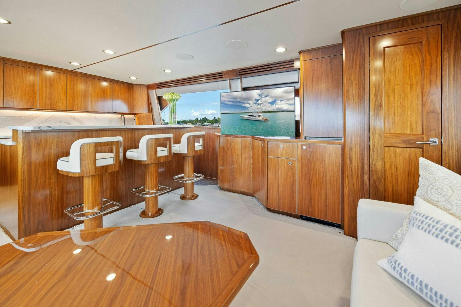 a room with a table and chairs aboard PLAN B Yacht for Sale