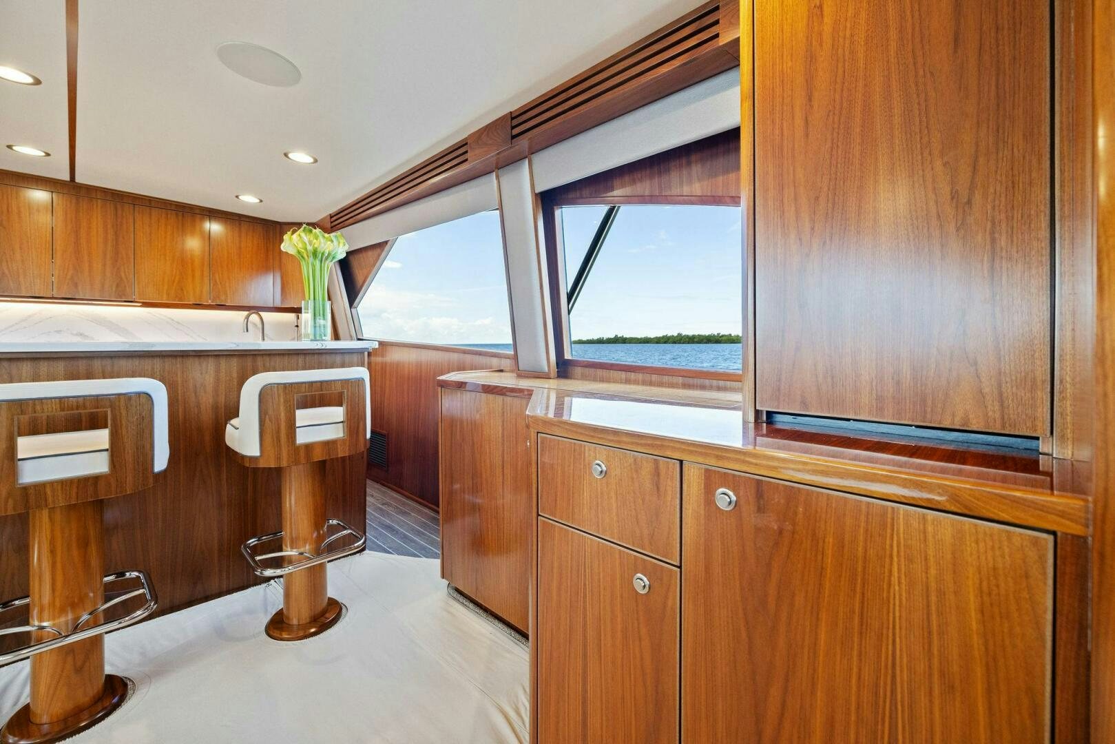 a bathroom with wooden cabinets aboard PLAN B Yacht for Sale