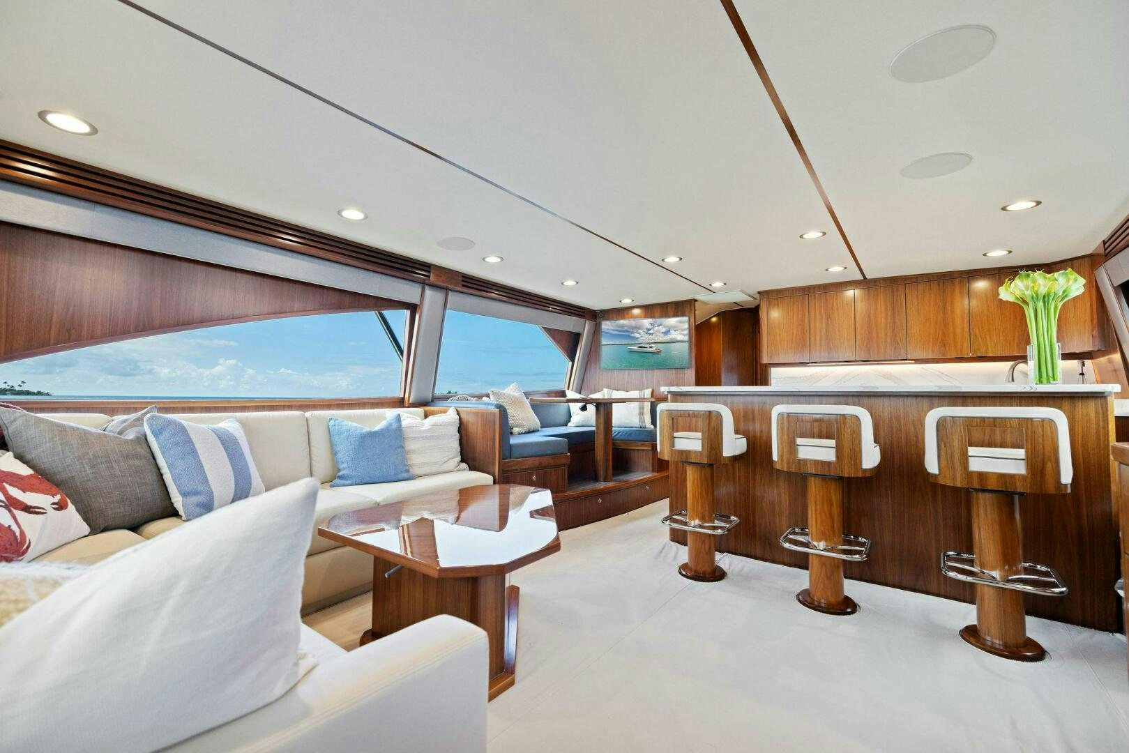 a room with a couch and a table and chairs aboard PLAN B Yacht for Sale