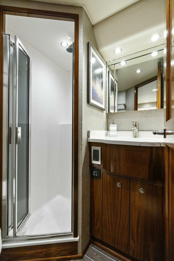 a bathroom with a large mirror aboard PLAN B Yacht for Sale