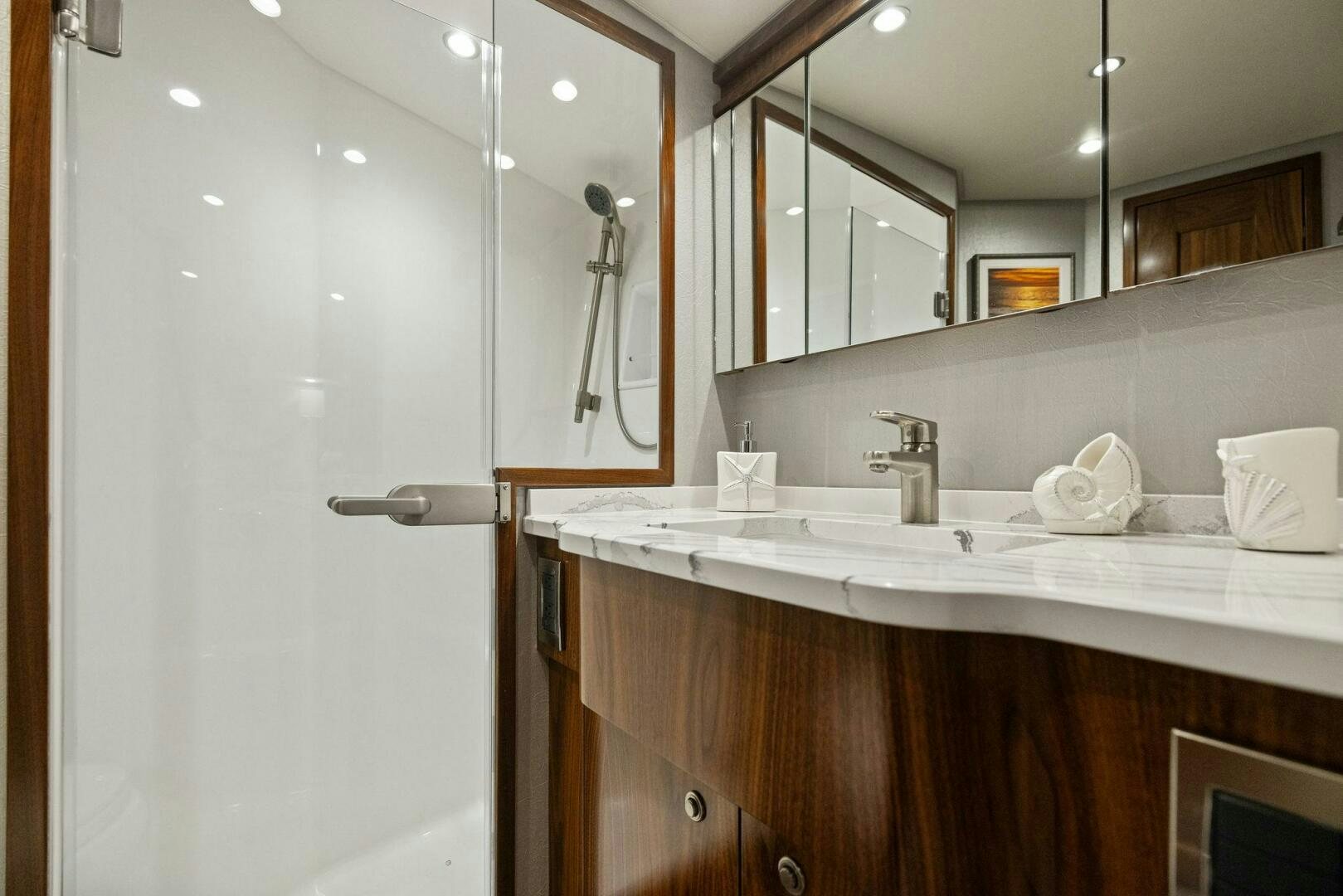 a bathroom with a large mirror aboard PLAN B Yacht for Sale