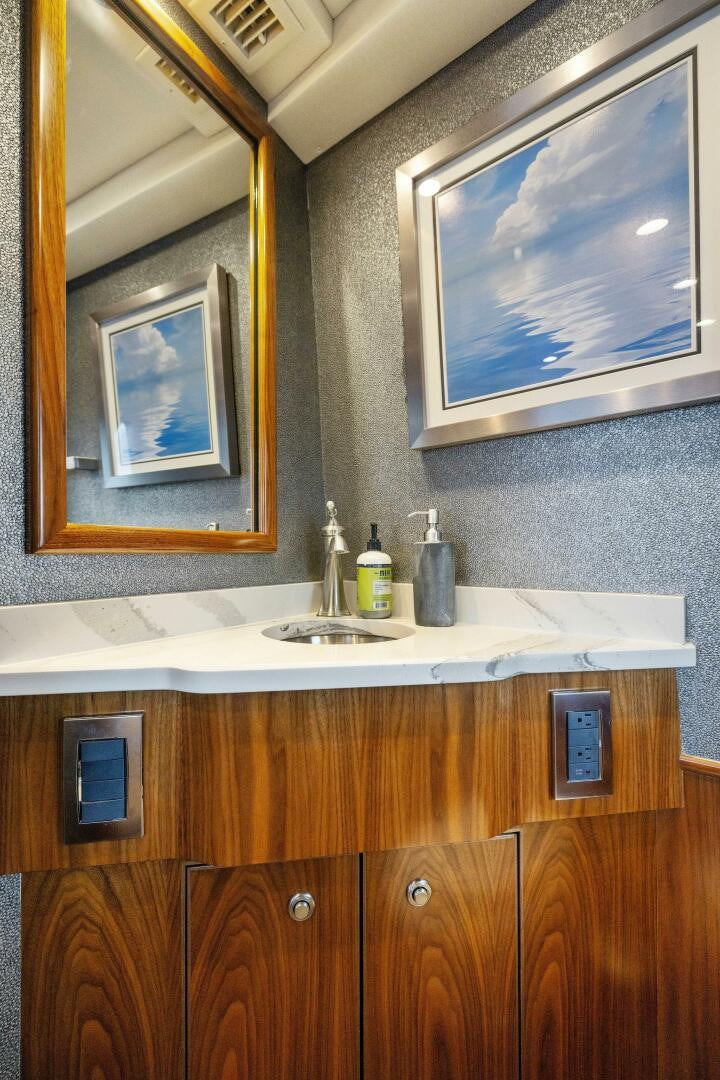 a bathroom with a sink and a mirror aboard PLAN B Yacht for Sale